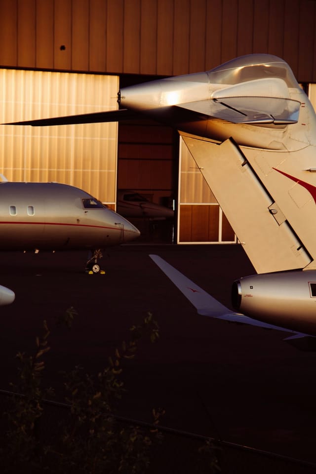 Private jets outside a hangar at golden hour