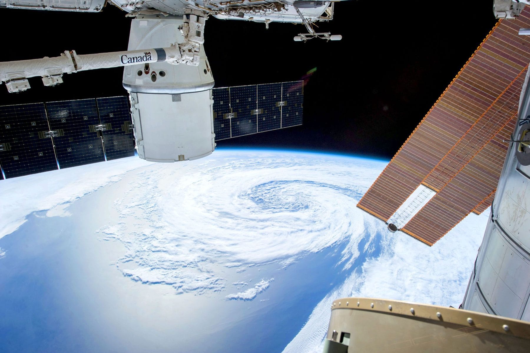 A large storm system swirling over the ocean, seen from orbit