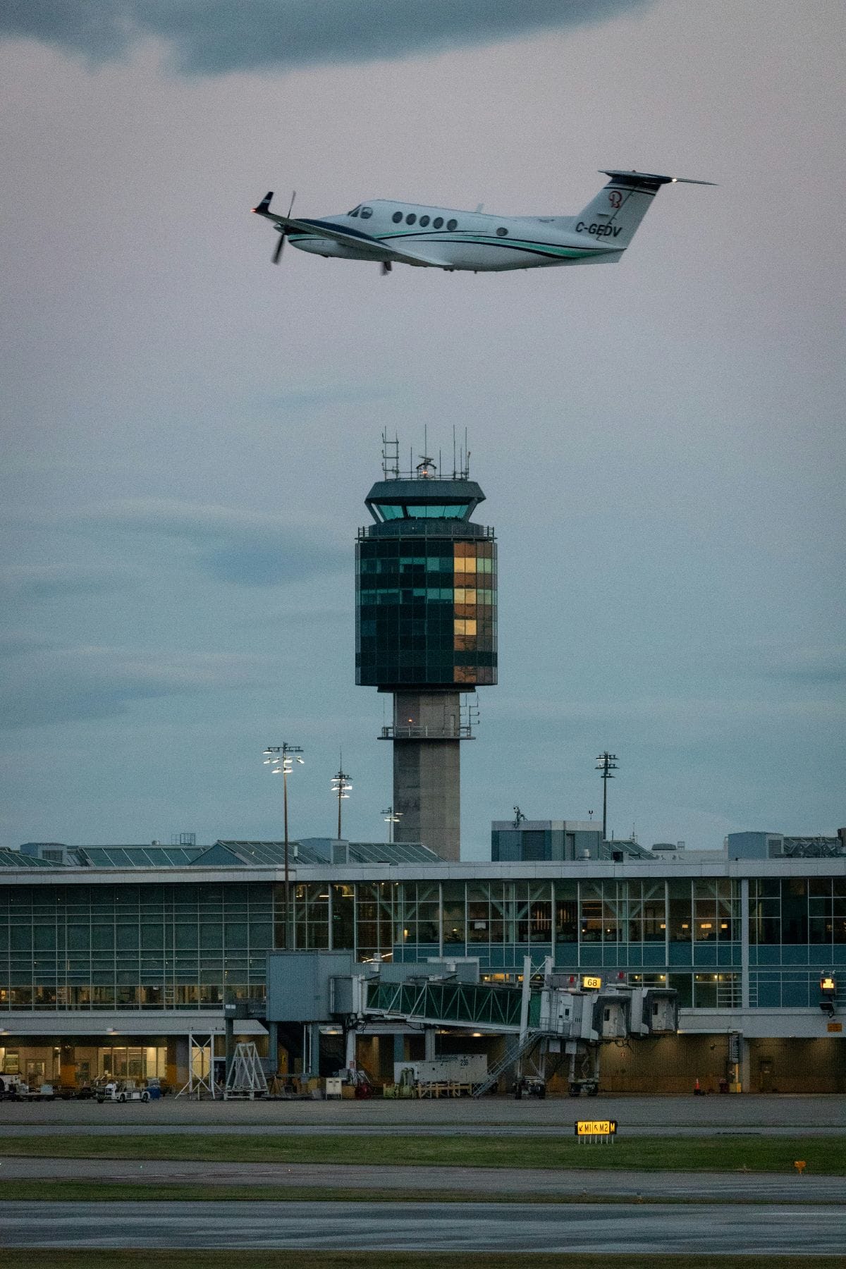 Air traffic control tower with a departing aircraft overhead